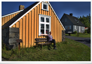 Our guide resting in front of the very type of house she was raised in.